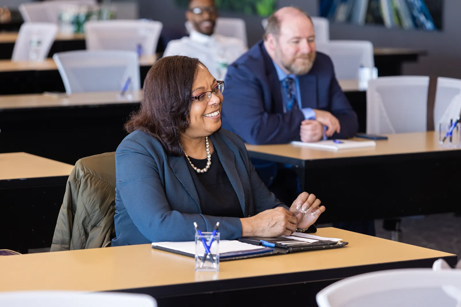 Professionals seated at tables during a session in Training Rooms B and C